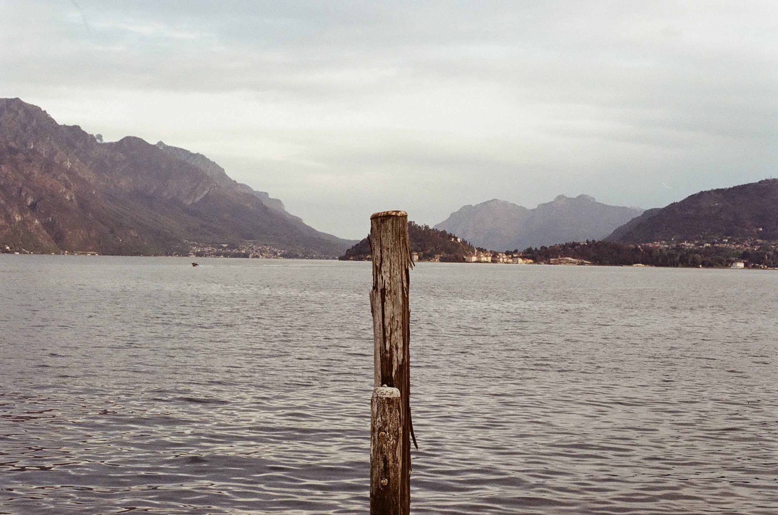 Lone tethering pole by Lake Como on film